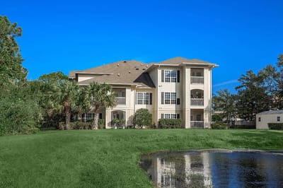 Exterior view of a senior living building with green space
