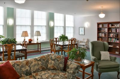 Bright common area with comfortable seating and bookshelves