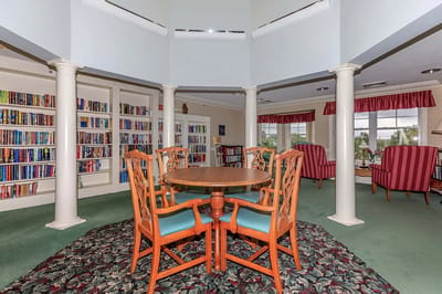 An interior common area with bookshelves and seating
