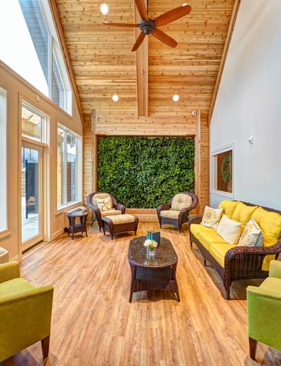 Bright common area with comfortable seating and greenery