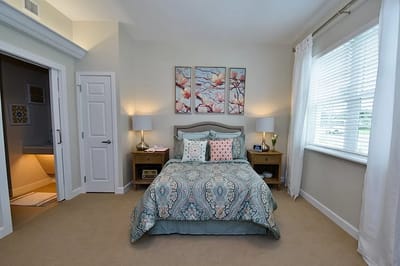 Brightly decorated private resident room with bed