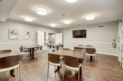 Common area with tables and chairs in a dining space