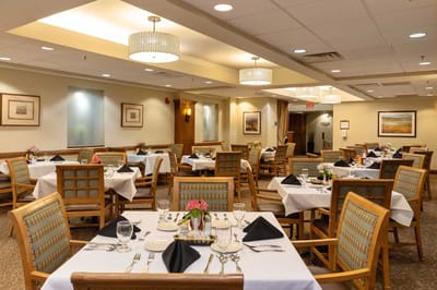 Dining area set up for a meal with tables and decor