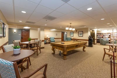 Bright common area with a pool table and seating