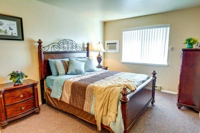 Cozy resident bedroom with wooden furniture