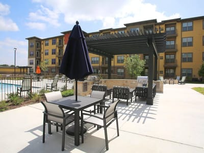 Outdoor seating area with a pergola near the building