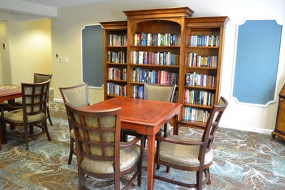 Interior view of a common area with bookshelves and tables