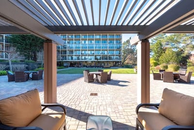 View of an outdoor seating area with the facility building in the background