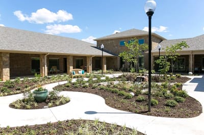 A beautifully landscaped courtyard with pathways and seating