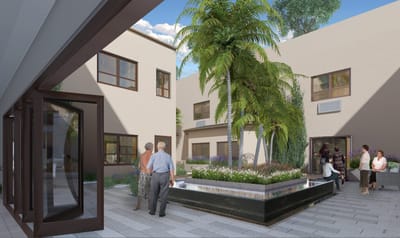 Residents enjoying a courtyard with palm trees and fountain