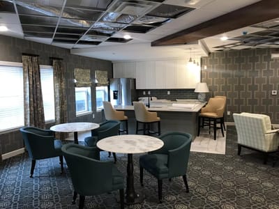 Interior of a common area with seating and kitchen