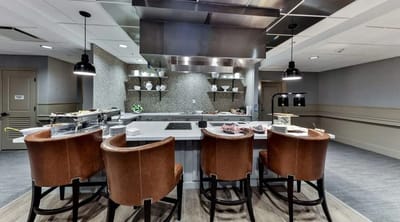 Modern dining area with brown chairs and cooking station