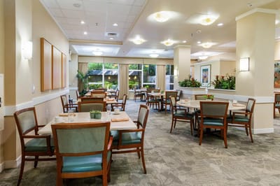 Dining area with tables and chairs in a well-lit space