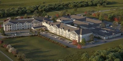 Aerial view of a senior living facility surrounded by greenery
