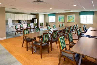 Bright common area with dining tables and chairs