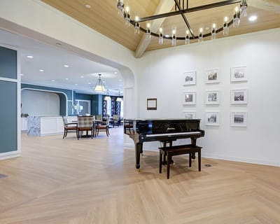 Interior of a common area with a piano and seating