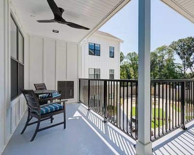 Balcony with seating overlooking a landscaped area