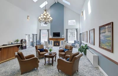 Bright common area with comfortable seating and a fireplace