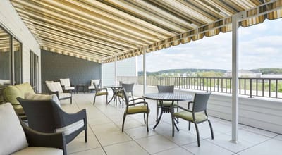 Outdoor terrace with seating and awning