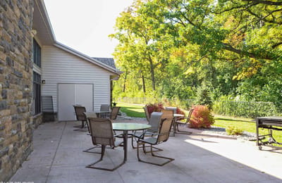 Outdoor patio seating area surrounded by greenery