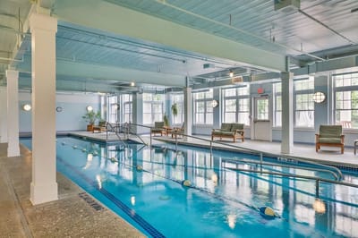 Indoor swimming pool area with lounge chairs