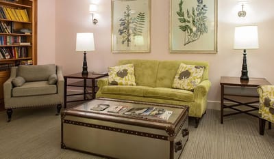 Cozy lounge area with seating and bookshelves