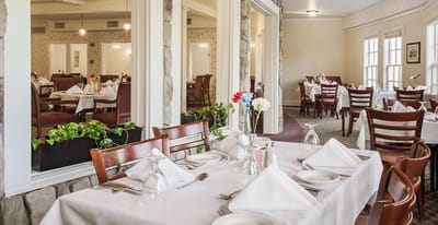 Dining area in a senior living facility with neatly set tables