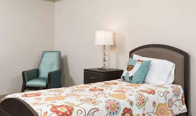 Cozy bedroom setup with colorful bedding and a lamp