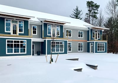 Exterior view of a new building covered in snow
