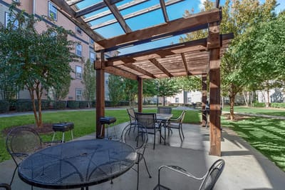 Outdoor seating area with pergola and tables