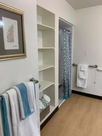 A clean bathroom interior with towels and shower