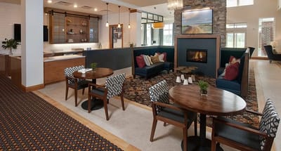 Modern lounge area with seating and fireplace