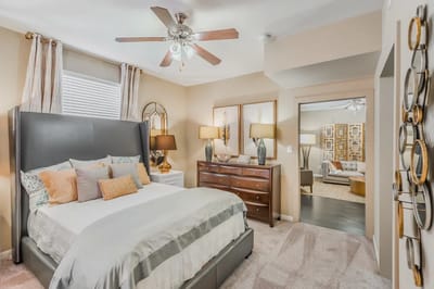 Well-decorated resident room with a bed and furniture