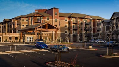 Exterior view of The Springs at Tanasbourne with parking
