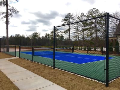 Outdoor tennis court with blue and green surfaces