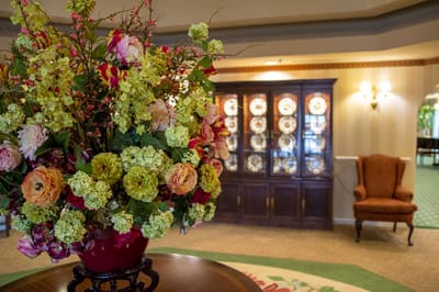 Brightly decorated common area with floral arrangement