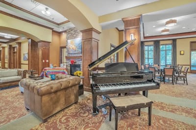 Cozy common area with a grand piano and seating