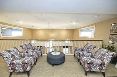 Common area with patterned chairs and a round table