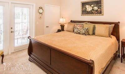 Bright interior of a private resident room with a bed