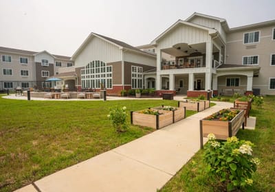 Exterior view of senior living facility with landscaped gardens
