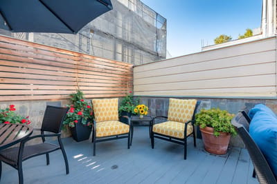 Outdoor seating area with flowers and sunflowers