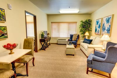 Brightly decorated common area with seating and natural light