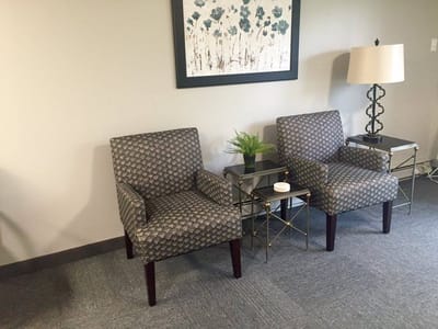 Cozy seating area with chairs and lamp