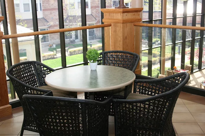 Common area with a table and chairs overlooking the garden