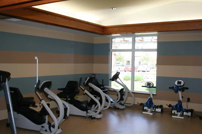 Fitness equipment in a well-lit exercise room
