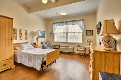 Interior view of a resident's room with a bed and furniture