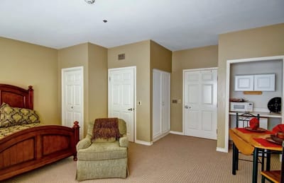 Interior view of a resident room with a bed and chair