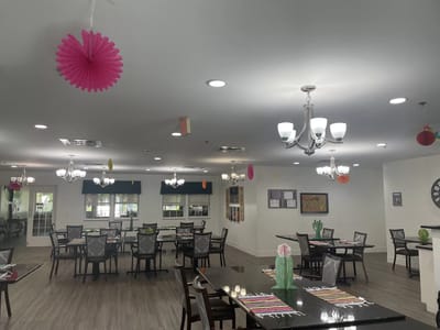 Dining area with festive decorations and dining tables.