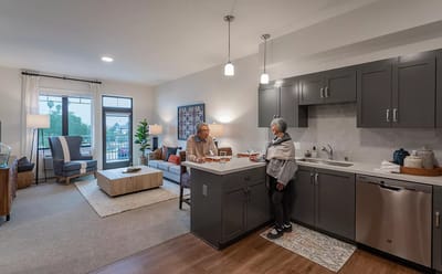 Two residents interacting in a cozy kitchen area