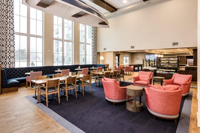 Bright common area with seating and tables